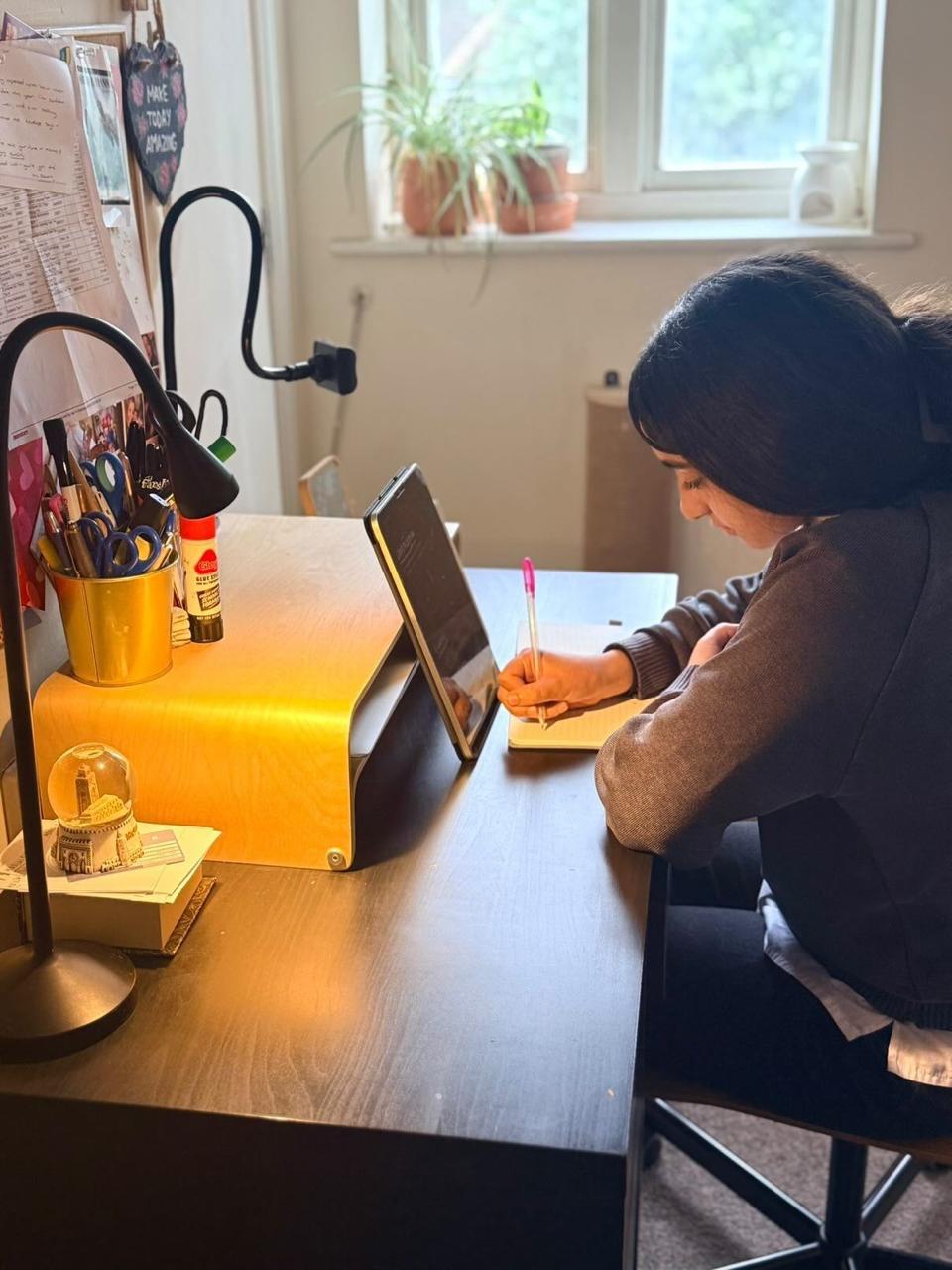 Student studying with Iman British Online School